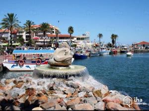 a fountain in the water near a marina with boats at L'Arletta in Saint-Cyprien-Plage +2 photos