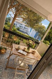a balcony with a table with flowers on it at L'Arletta in Saint-Cyprien-Plage