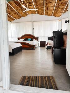 a bedroom with two beds and a flat screen tv at Huiltana ecohotel&resort in Guataquí +63 photos