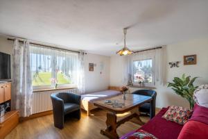 a living room with a couch and a table at FeWo Spreequelle in Herrnhut
