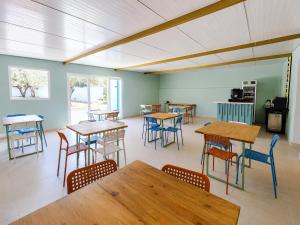 a dining room with tables and chairs in a room at Quinta da Ponte das Hortas 2 in Elvas