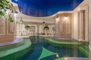 an indoor pool with green water in a building at Sonata Hotel in Kyiv