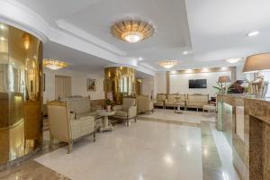 a lobby with couches and chairs in a building at Sonata Hotel in Kyiv