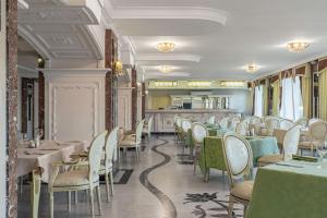 a restaurant with tables and chairs in a room at Sonata Hotel in Kyiv