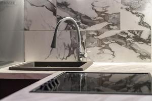a kitchen sink with a faucet on a counter at Voika majutus in Voika +14 photos