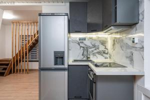 a kitchen with a refrigerator and a sink at Voika majutus in Voika