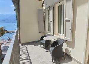 a balcony with chairs and a table on the side of a building at M Loft - adults only in Malcesine
