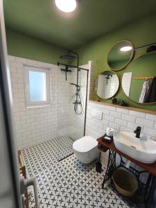 a bathroom with a sink and a toilet at Holiday Home Kostandinovic in Modriča +22 photos
