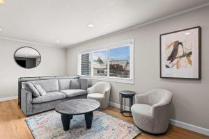 a living room with a couch and two chairs and a table at Newly Renovated Unit in Central Spfld #301 in Springfield