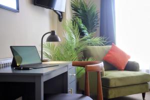 a desk with a laptop and a chair in a room at SixCheapStreet in Newbury