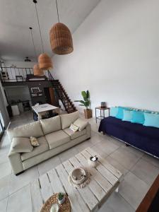 a living room with a couch and a table at Loft Amplio y moderno con parque CASARENT in Carlos Casares