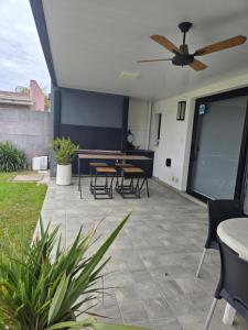 a patio with tables and chairs and a ceiling fan at Loft Amplio y moderno con parque CASARENT in Carlos Casares +2 photos