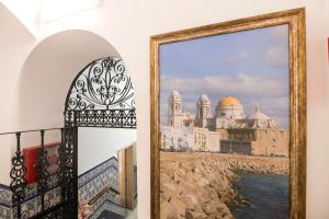 a painting of a view of a city at Hostal Colón Don Miguel in Cádiz +53 photos