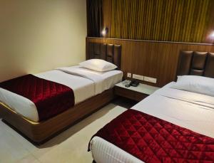a hotel room with two beds in a room at Hotel Royal Stay in Madurai