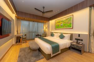 a hotel room with a bed and a television at Weekend Retreat- Hotel & Spa in Kurseong