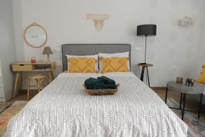 a bedroom with a bed with a basket on it at Ammos studio Loutraki in Loutraki
