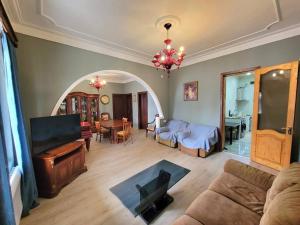 a living room with a couch and a table at Дом in Kobuleti