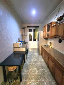 a kitchen with a counter and a refrigerator at Дом in Kobuleti