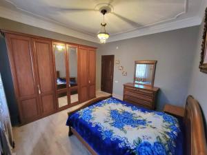 a bedroom with a bed and a dresser at Дом in Kobuleti