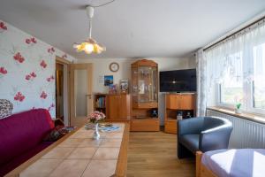 a living room with a couch and a table at FeWo Spreequelle in Herrnhut