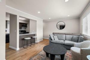 a living room with a couch and a table at Newly Renovated Unit in Central Spfld #201 in Springfield