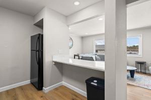 a kitchen with a black refrigerator in a room at Newly Renovated Unit in Central Spfld #303 in Springfield +11 photos