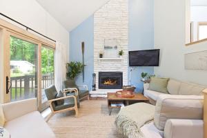 a living room with a couch and a fireplace at La Maison du Lac in Sawyer