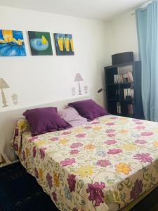 a bedroom with a bed with a floral bedspread at Les Marais 2 in Le Pré-Saint-Gervais