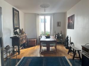 a living room with a table and a window at Les Marais 2 in Le Pré-Saint-Gervais
