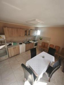 a kitchen with a table and chairs in a room at Peščani breg in Banatski Karlovac