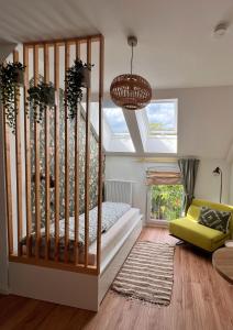 a bedroom with a bed and a skylight at Das Jaartn - Boardinghouse Appartements & Ferienwohnung in Schönefeld
