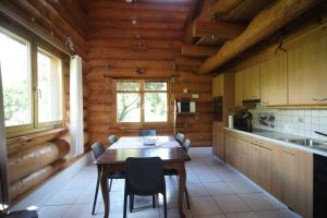 a kitchen with a table and chairs in a cabin at Le Gîte de Briey - Chalet complet in Chalais