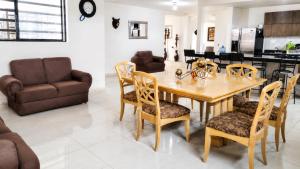 a dining room and living room with a table and chairs at Casa Oasis Aguascalientes in Cañada del Rodeo