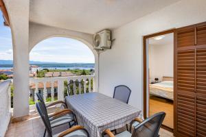 a balcony with a table and chairs and a bed at Rooms Vera in Porat