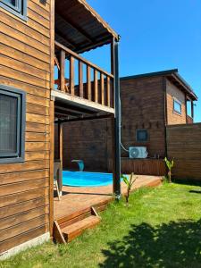 a house with a deck and a swimming pool at Villa Myra in Beymelek +13 photos