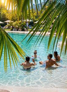a group of people sitting in a swimming pool at Terme di Relilax Boutique Hotel & Spa - Adults Only in Montegrotto Terme