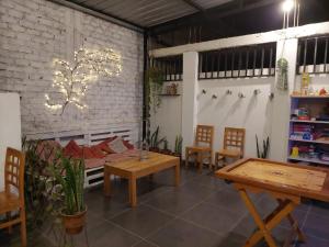 a room with tables and chairs and a brick wall at JUMANA in Nazca