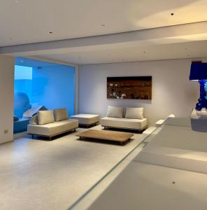 a living room with two couches and a couch at Fenici Levanzo Hotel - Adults Only in Levanzo