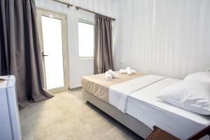 a bedroom with a bed with two towels on it at Southern Nights in Gjilek