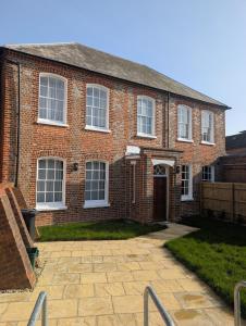 a brick house with a driveway in front of it at SixCheapStreet in Newbury
