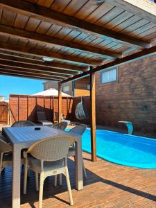 a patio with a table and chairs and a swimming pool at Villa Myra in Beymelek