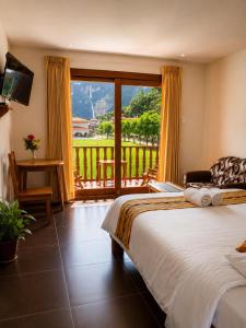 a bedroom with a large bed and a balcony at Balcon de Gocta in Cocachimba