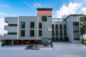 a large white building with a lot of windows at Weekend Retreat- Hotel & Spa in Kurseong