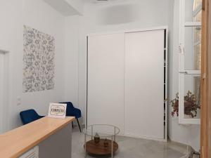 a kitchen with a glass door and a desk at Hostal Colón Don Miguel in Cádiz