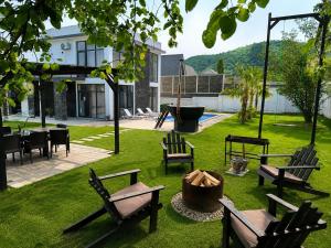 a group of benches sitting in a yard with a playground at Qafqaz Mandarin Deluxe in Gabala