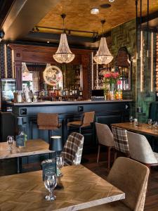 a restaurant with tables and chairs and a bar at Hotel Grodzki Business & Spa in Stargard