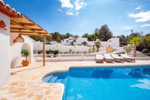 a villa with a swimming pool and a house at Villa Mawaki Calpe in Calpe