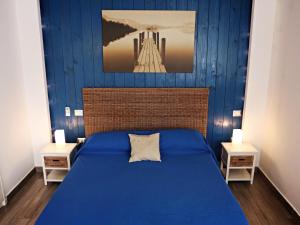 a blue bedroom with a bed and two night stands at Beatrice Home in Pompei +89 photos