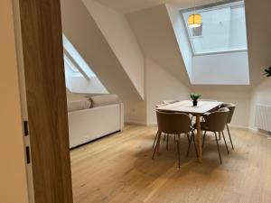 a dining room with a table and chairs and a window at Modern Apartment in Döbling in Vienna