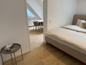 a bedroom with a bed and a table and a chair at Modern Apartment in Döbling in Vienna